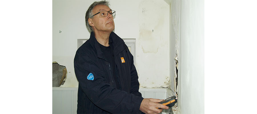 The Homes Act - A Peter Cox employee testing damp in a home